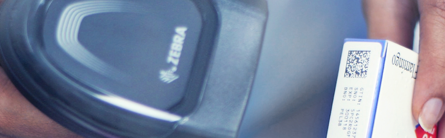 A close up of a carton with serialisation being scanned